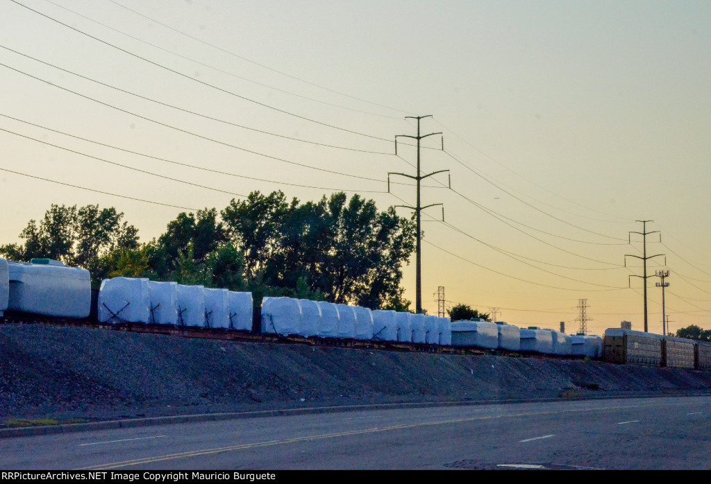 QTTX & KRL Flat cars with load in the yard